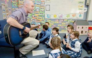 StDeclansPrimarySchoolPenshurst Teacher playing guitar to students